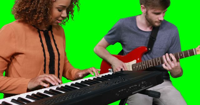 Musicians playing piano and guitar against green screen