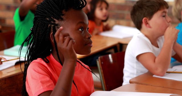 Curious Elementary School Girl Listening Attentively in Classroom - Download Free Stock Images Pikwizard.com