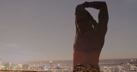 Cityscape Encapsulating African American Man Stretching Outdoors at Dusk - Download Free Stock Images Pikwizard.com