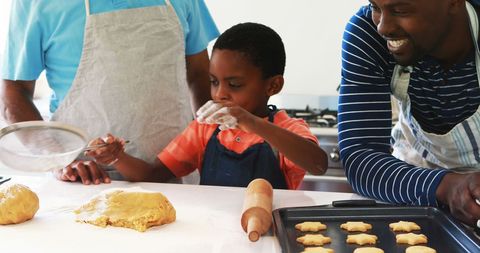 Young Boy Baking Cookies with Family in Kitchen - Download Free Stock Images Pikwizard.com