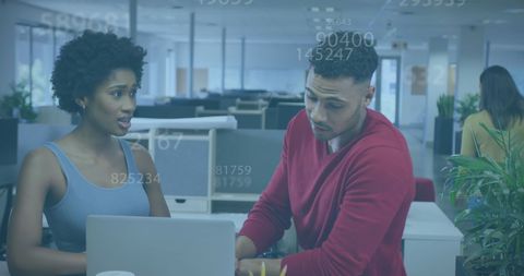 Colleagues Discussing Data in Modern Office Environment