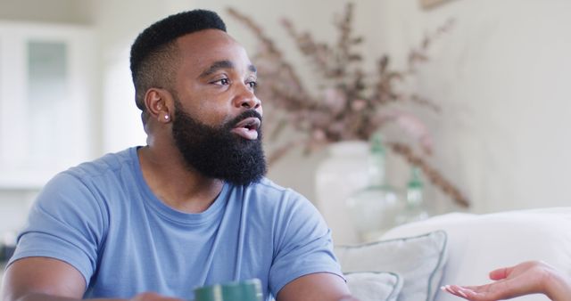 Man Engaging in Conversation Over Coffee in Cozy Home - Download Free Stock Images Pikwizard.com