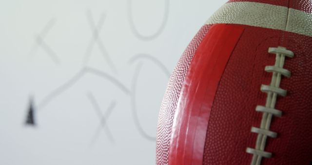 American Football Close-Up with Play Diagram in Background - Download Free Stock Images Pikwizard.com