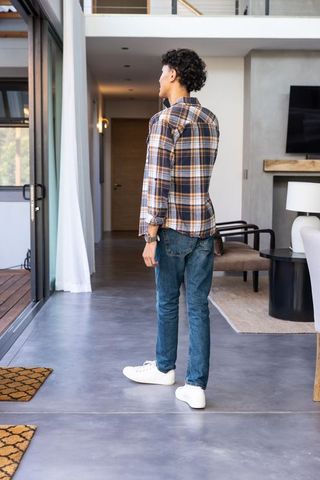 Man Relaxed Against Modern Living Room Backdrop with Glass Doors