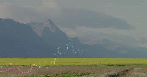 Serene rural landscape with overlaid financial graph and mountains