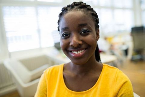 Smiling Businesswoman in a Bright Office Environment