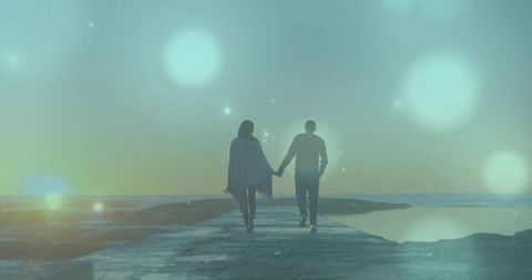 Romantic Couple Holding Hands at Sunset with Lens Flares