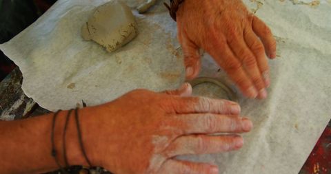 Senior crafting clay in ceramic art mastery