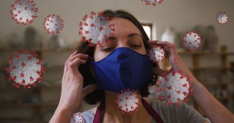 Woman in Pottery Studio Adjusting Mask Amid COVID-19 Concept