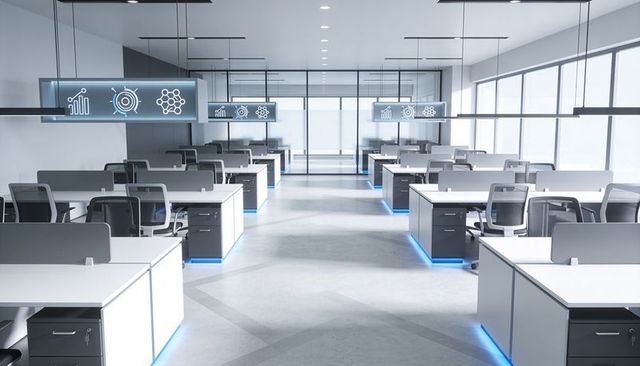 Futuristic open-plan office showcasing white workstations, glass partitions and blue led lighting