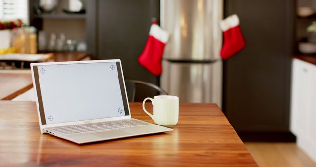 Cozy Kitchen Workspace with Laptop and Coffee Mug During Holidays - Download Free Stock Images Pikwizard.com