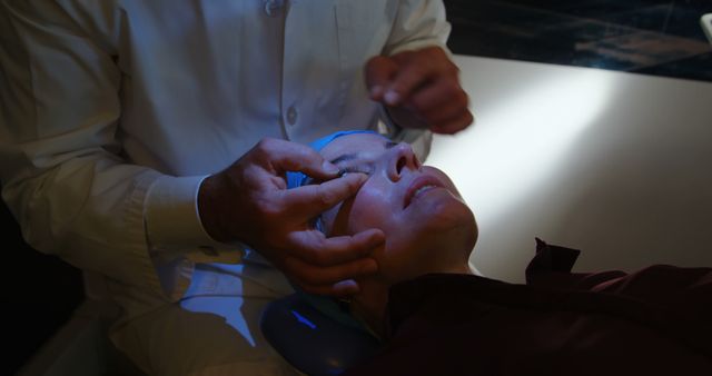 Depicting a cosmetic surgeon performing facial procedures on a female patient in a clinic, this can be used in websites and marketing materials related to beauty clinics, cosmetic surgery, and medical aesthetic services. Ideal for illustrating professional treatment in the healthcare and beauty industry.