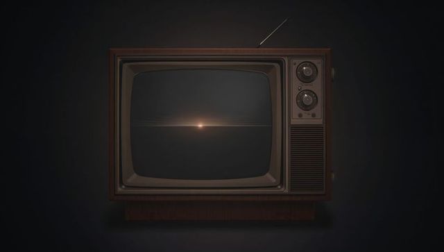 Glowing vintage wooden CRT TV sitting center in dark studio showing faint screen flare