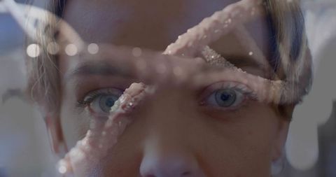Ethereal double exposure portrait woman with crystal branch overlay and cool blue bokeh