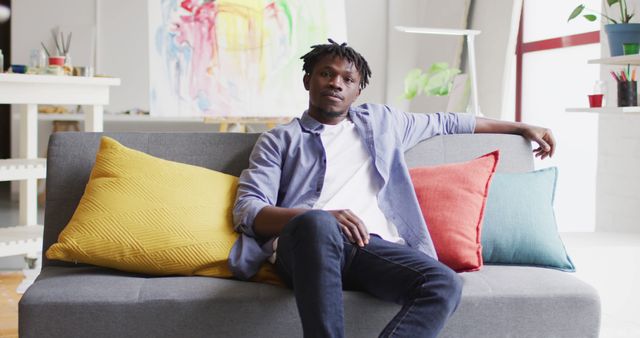 Relaxed Man Sitting on Sofa in Modern Living Room - Download Free Stock Images Pikwizard.com