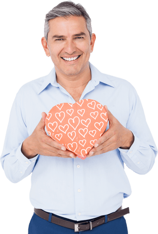 Smiling man holding heart-shaped gift box transparent background