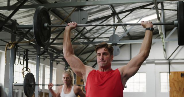 Man Lifting Barbell Overhead in Gym, Intense Workout - Download Free Stock Images Pikwizard.com