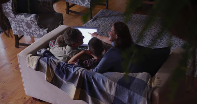 Family Cuddling Together on Couch Watching TV Evening Cozy Time - Download Free Stock Images Pikwizard.com