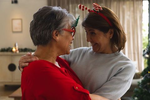 Mother and daughter sharing a festive christmas embrace