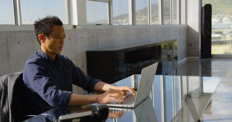 Young Businessman Working on Laptop in Modern Office - Download Free Stock Images Pikwizard.com