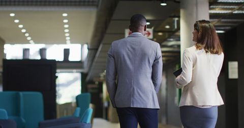 Business Professionals Walking and Talking in Modern Office