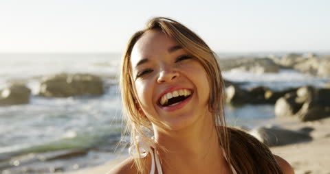 Smiling Woman Enjoying Beach Vacation on a Sunny Day