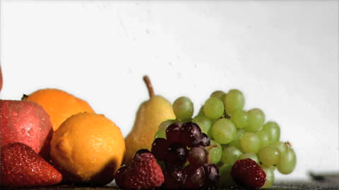 Fresh Assorted Fruits Under Rainfall in Slow Motion
