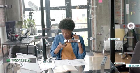 African American Businessman Analyzing Data on Smartphone in Office