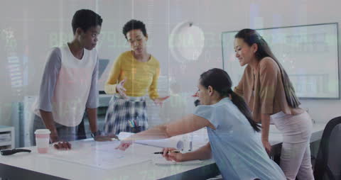 Diverse Women Collaborating on Financial Strategies in Office