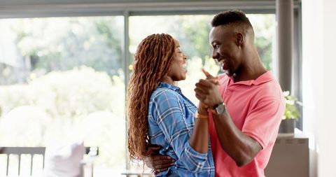 Couple Dancing Happily in Living Room