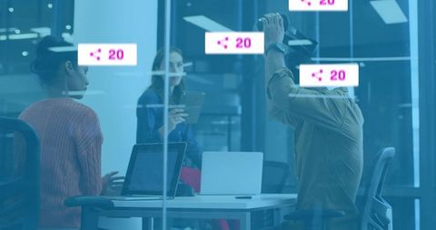 Modern Team Collaborating in Glass-Walled Conference Room