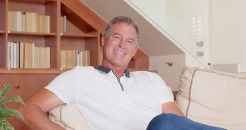 Relaxed Middle-Aged Man Enjoying Leisure Time on Sofa