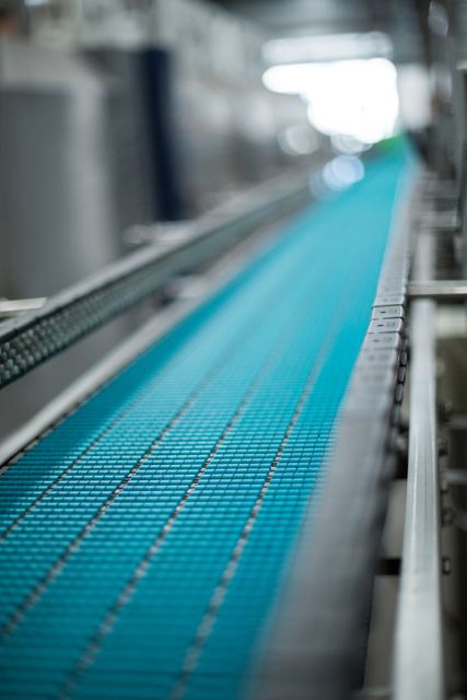 Close-up of conveyer belt in bottle factory