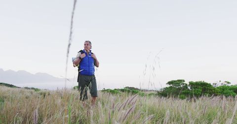 Senior Adventurer Hiking Through Mountain Grass Fields - Download Free Stock Images Pikwizard.com