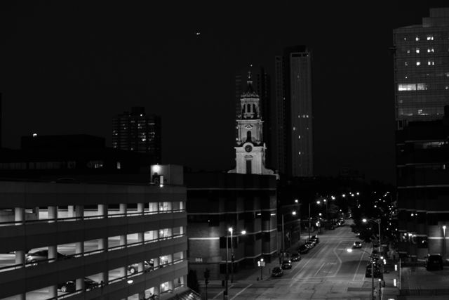 Black and White Cityscape at Night with Illuminated Church Tower - Download Free Stock Photos Pikwizard.com