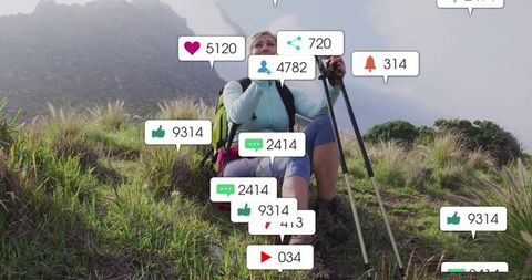 Hiker Engaging with Social Media Notifications in Mountain Landscape