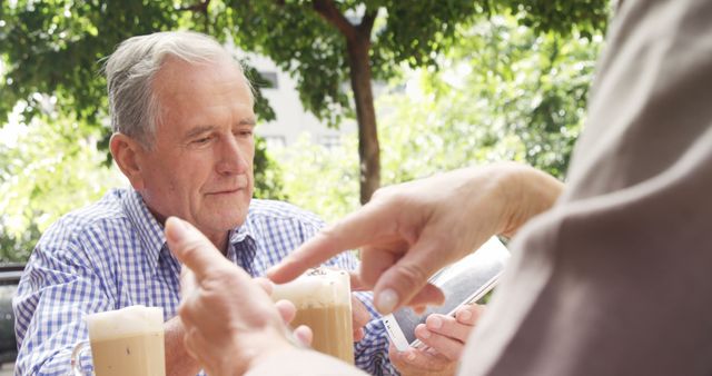 Senior Man Enjoying Coffee Conversation Outdoors in Garden - Download Free Stock Images Pikwizard.com