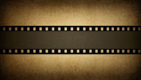 Vintage filmstrip on aged sepia paper featuring blank center frame for text overlay