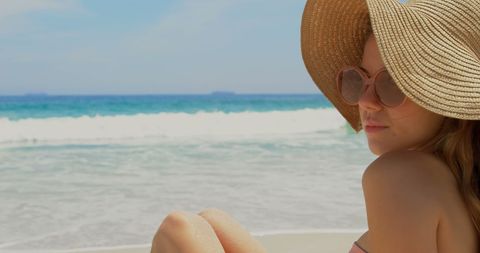 Woman in Sun Hat Relaxing by Ocean on Sunny Day - Download Free Stock Images Pikwizard.com