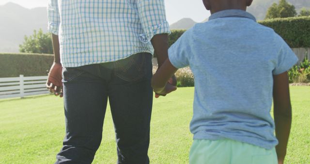 Father and Child Holding Hands Outdoors on Sunny Day - Download Free Stock Images Pikwizard.com