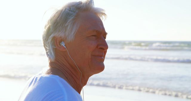 Senior Man Enjoying Music at Beach during Sunset - Download Free Stock Images Pikwizard.com