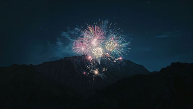 Spectacular fireworks illumination over mountain landscape at night