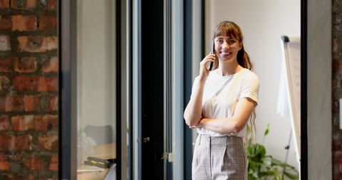 Professional Woman Communicating on Phone in Modern Office