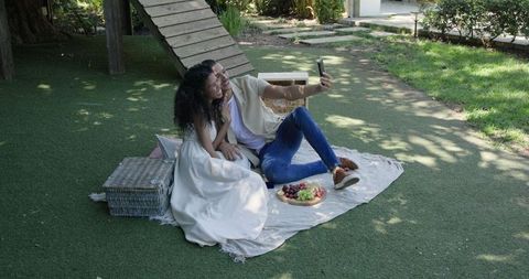 Couple Enjoying Picnic Selfie in Sunny Garden