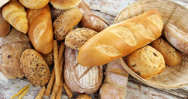 Assorted Freshly Baked Bread Loaves and Buns on Rustic Table - Download Free Stock Images Pikwizard.com