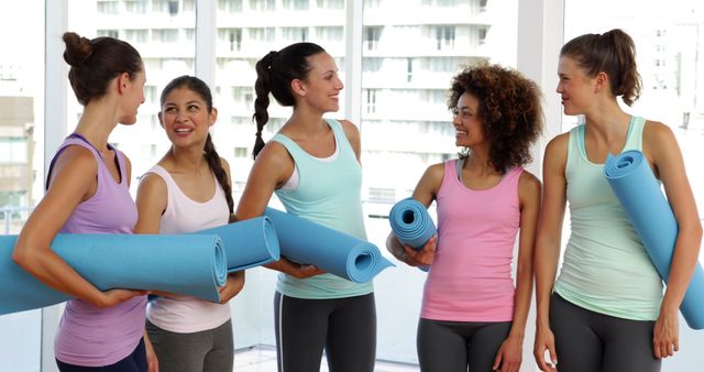 Group of Diverse Women Holding Yoga Mats in Studio - Download Free Stock Images Pikwizard.com