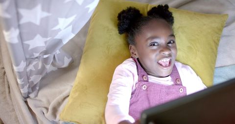 African American Girl Having Fun with Tablet Indoors