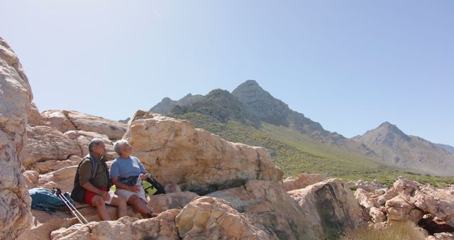 Senior Couple Resting During Mountain Hike in Rocky Landscape - Download Free Stock Images Pikwizard.com