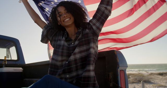 Joyful Woman in Plaid Shirt Holding American Flag at Beach - Download Free Stock Images Pikwizard.com