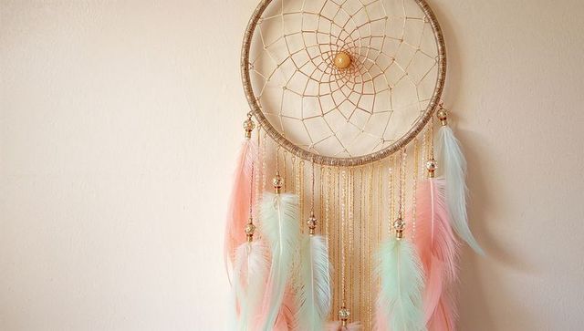 Boho Dreamcatcher with Pastel Feathers Hanging on Wall